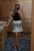 This skirt fits perfectly and is not too short with the tassels. I got tons of compliments! It has no stretch but a small fit well which is what I normally order for bottoms at Lulus. - Isabel W.