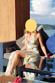 I wore this dress to a destination wedding. I tend wear a medium in most clothes, but based on reviews, I ordered a small and an extra small. The small fit great. I'm small chested, usually a 36A or B, and felt like the top of the dress suited my body type. I think I would have felt overly exposed if I had a larger bust, as any time I tried to add something with padding to the top, it gaped open. I had trouble finding the right undergarments to wear with this, so I did what other reviewers suggested and settled on silicon pasties, and also used fashion tape to secure the edge of the fabric to my chest. When I sat, I still felt worried that the fabric would fall open, but I don't think I had any wardrobe malfunctions. I felt very pretty in this dress. The weight of the fabric made it feel fancy and appropriate for the occasion. I didn't feel too hot despite the tropical weather. I loved the print and felt like it very subtly stood out among a sea of solid color dresses. - Tessa C.