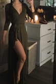 This dress is super cute. It's a wrap dress so the slit is very high but does not open up unless you stick your leg out. It is very low cut but I fixed easily with a little clip. - Laynee A.
