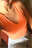 Already reviewed this in black but just got the coral and just as obsessed! The top is lined and comfortable. Easy to dress up or down! The lighter color makes it a little easier to tell if you aren't wearing a bra but the top would be easy to wear a bra with (pic is w/o and I don't think you can tell). Must have, I'll probably order the light blue next! - Jacqueline G.