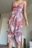 This dress fits me like a glove. I was a little worried with the other reviews saying it's too big, but I love it! Plus it has adjustable straps. I could see how it would be too long if you're shorter, but love the length on me. It flows super nicely and will be perfect for the summer wedding I'm attending. It does have a clip for the bust (see second picture) but since I'm bustier I prefer to leave it open (first picture). - Brittany H.