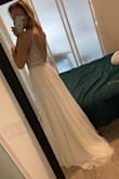 This dress is incredibly good for the price. The top is intricate and sparkles a lot more than I expected. I'm still on the fence if this is "THE" dress but it's a strong contender. Be aware for Canadian brides this took 5 weeks to arrive and cost $50+ in customs. I went for a size 4 although the online measurements suggested a size 6. I'm very happy I chose the smaller size since it fits me like a glove. Has a little train which was a happy surprise. Although I am taller than average the skirt is still too long and I will have to have it altered if I choose to keep it. - Emilie C.
