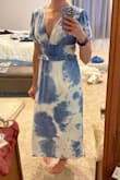 Just got in the dress in the mail and love it! The material is SO soft and seems to be pretty wrinkle resistant which I love. I'm usually between a small and a medium and went with a small and I'm happy I did. The small fits me perfectly so I think I would have been swimming in a medium. It's pretty low cut so you'll need either the right kind of bra or a bralette with it. I can't wait to wear this! - Laura M.