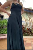 It fits well around my waist, but it's very long. I had to get it hemmed and the slit also goes to my belly button so I had to add a few stitches in myself. It also isn't as green as appears in photo. - Megan C.