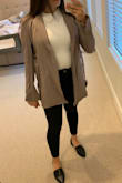 The material is like spandex. It feels like a sporty dry-fit material. Not quite what I had expected, but still cute. It's also super comfortable. In some ways, I think it's hard to dress up because it looks a little sporty in person, but I've worn it under jackets and blazers and it's been okay. - Hannah C.