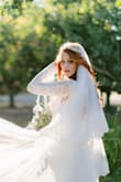 Ordered this dress wanting long sleeve lace and a simple bottom. Like most Lulus dresses the length was long and perfect for my height (I could even wear heels). In order to make it more Bridle like in appearance I added Swarovski Crystals to the lace pattern, a cathedral lace-trimmed veil with matching Swarovski crystals and a crown. The simple flowy bottom allowed the added details to shine. Steaming this dress took AGES and hanging for a long time will not relax the wrinkles, because it is synthetic material only a low heat steamer could be used. - Jessa K.