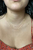 I like the necklace and that it hangs three thin chains. However, it does get tangled. Sometimes I reach for my necklace and find it braided. - Astrid A.
