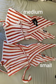 I ordered this romper a few years ago in a small and it has been one of my very favorite pieces. Over the years it has shrunk as I've washed it so many times, and I decided to order again in a bigger size (medium). I was so excited when the medium came back in stock, but I tried the new one on and it was incredibly short. The inner liner was longer than the shell of the romper, to the point where it hung out of the bottom. I compared it to my small of the same item, and the small is at least two to three inches longer than the medium. Either the item I received was sized incorrectly, or someone washed it, shrunk it, and then returned it and I was sent the damaged product. Sad to return, but it is way too short and shrunken to wear. - Katie C.