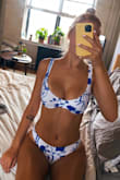 I am in love with this! The colors are vibrant and make my tan POP. Overall, this is a sittin' pretty swimsuit and not recommended for tubing/water sports or high levels of activity (if you have a larger chest). 

Pros:
Fabric quality
adjustable straps
Fits true to size (I also looked at the Charlie Holiday website to get more review information on fit)
Vibrant coloring

Cons:
Metal clasp comes undone easily if the band is loose around.
Band is not adjustable (think swimsuits with a metal hook and several notches to adjust based on your band size) - Kay H.