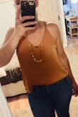 Color is fantastic and I love it! BUT, I wanted it to tuck and drape like the photo in the ad, but it's just a little too short for my torso. It will only do it in a super high waisted jean. And I wish the straps were longer so it would hang lower in the front. It hangs in the back like the photo. - Alexis C.