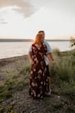 This is such a beautiful dress! I ordered this dress for our engagement pictures. I got an XS which was very long for me, but I am on the smaller side. I had this dress hemmed and ended up wearing 3" heels with it so it just grazed the ground. It is a wrap dress which is great so you can tighten/loosen it as needed. I ended up using a safety pin on the chest of the dress. There is a little clasp closure, but it was a little too low for my liking. Overall, very pretty flowy dress! 10/10 - Alicia P.