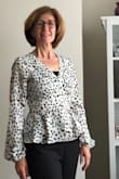 This is light weight breathable and still looks great. I was surprised that the sleeves have elastic at the wrist, but surprisingly I don't mind them. I usually wear an XS for tops but ordered an S because of other feedback. It's a tiny bit loose but it works. It is low cut so a cami is necessary. - Kathryn M.