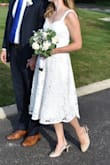 I wore this dress to my last minute wedding "minimony." We got married on an 87 degree day, but the weight of the material was very comfortable. As many of the reviews have said, the top was a little large (I have a smaller chest) and the straps were quite long. However, after alterations, it fit me perfectly. Even though the fit wasn't perfect, I still give this dress 5 stars. I think I might like it more than the real wedding gown that I plan to wear next year! - Samantha L.