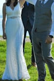 We planned an elopement in 2 weeks, and this dress delivered! I ordered a jeweled belt from Amazon in rose gold and did a few other rose gold accessories, and I loved the overall look. This dress runs long. I am 5'3" and wore 5.5" heels, and it still needed to be hemmed an inch. People were shocked I was able to get a dress in two days for this price. By the end of the night, this dress did have some snags and pilling near the armpits from rubbing, but that's to be expected, and it's a wedding dress; I am not planning to wear it once a week for the foreseeable future so it isn't a problem. - Laura B.
