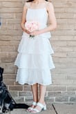 Our wedding has been pushed back 1.5 years due to covid, but we decided not to wait to sign the paperwork! This dress fit absolutely perfectly and was light and airy for a hot July day in DC. Got so many compliments on how fun and stylish it was. Didn't experience any fuss with the zipper or the pom poms. - Paige L.