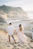 I absolutely love this dress and the color was prefect for our engagement photoshoot setting. It is a wrap dress and where we took our photos (cape kiwanda) was very windy at times so, I had to make sure the dress didn't open up and our photographer had us run a lot and be spontaneous which was hard to do because I had to make sure the dress wasn't opening up. This would absolutely be the most perfect dress had it not been for the way it was cut and sewn around the chest aarea. Some of the pictures we wanted to use for the invites we couldn't because of the chest area. The material is great quality and is easy to wash. I was afraid i stained it because I was walking on wet rocks and sand but it came right out. I love the button details which adds so much to your photos! I would recommend buying it if you don't have any issues with a revealing chest! - Elizabeth A.