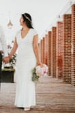 I wore this for my elopement and was very happy!
The fabric is thick, soft, and stretchy. The dress was long but I hemmed it at home and it wasn't a particularly tricky fabric to work with. You could actually just cut it and not sew the hem in a pinch, because the cut fabric is very smooth, doesn't look ragged.
I'm on the small side of Medium on top on big side of Medium on the bottom. I bought the medium in this dress and ended up returning it because it was really tight on the bottom. I was worried that the large would be too big on top, but I think it was fine!
I wouldn't recommend for bustier girls (see my pics to compare). - Hajung Y.