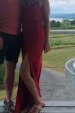 I love this dress! It's very simple but adds a hint of sexy with the thigh slit. I have this dress in both red and black. With that being said...I had a hard time finding the right size. I ended up keeping the small in the red and sized up with a medium in black. The red was a little snug in my hip/thighs but not enough to switch. The black was too tight in a small but the medium fit perfectly. Oddly, the medium black dress was shorter in length compared to the red small. It was hard to wear flats with the red, as it drug on the ground. Keep that in mind when ordering- size and length tend to vary but it was worth figuring it out! See attached photos. - Tara R.