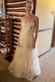 This is going to be my makeshift wedding dress for our small wedding ceremony. Our big wedding was postponed due to Covid. It is absolutely gorgeous and looks just like the picture. The material is very nice and flowy. It is definitely too long but can be hemmed without too much effort. I sized between a small and medium and I ordered both. I decided to keep the small. It is a little tight up top but the medium was a little loose. There is a nice sticky material on the top lining to keep the dress from sliding. - Lindsey C.