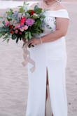 After changing our venue from a church to the beach, I needed something to fit the mood. I was in between sizes but with the stretch in the material, I was able to comfortably size down. It was actually perfect for the setting and the slit is a sexy touch, but not uncomfortable. I walked up and down stairs on camera and didn't have an issue. Definitely get some shapewear. The fabric is thick and heavy, so no flying in the wind, but can show unwanted curves haha, 
The only reason for not giving a 5-star is the folded neckline sometimes rolled up in a funny way and it's REALLY long.
Other than that, shipping was fast; the return process was easy (even during COVID!). Still felt like a bride in the middle of all the madness. Thank you. - Valeria L.