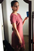 When I first got this dress, I loved it. The "rusty rose" color and the cut out back are lovely, and the material is comfortable and high quality.  It does wrinkle easily - even just sitting down will leave wrinkles - but luckily they come out completely with my steamer. 

After the first wear, however, I noticed a stain, so I gently hand washed the dress in cool water with about 1 tablespoon of detergent before leaving it out to air dry. The dress shrunk significantly! Before washing, it hung loosely. Now about 1.5 inches of the slip underneath is now visible, and it looks more like a body-con dress. I'm disappointed that it's lost its original shape and lightness. 

The pictures I posted are before washing - Rachel W.