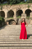 I wore this dress in Rome and absolutely loved it. The strings for the wrap were well attached (which, let's be honest, is super important!) and the fabric is so comfortable! I totally felt like the woman dancing emoji while wearing it & it was glorious. Amazingly vivid red in color & the fabric has kind of wrinkled texture so if it gets wrinkled, they just blend in. Also, the little "kind of sleeves" covered up just enough of my upper arms (bat wings) to make me feel comfortable. 10/10. - Ainslee W.