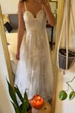 I purchased this for a reception dress for my wedding, and it did not disappoint! It is very well made and looks a lot more expensive than in the photos! I would say it fits true to the size charts. - Michaela S.