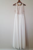 This dress was purchased for my wife's wedding 'reception' dress. She changed into it after dinner for something comfy to dance in. The length was good for her, as she is 5'7'' but may have been too long for anyone not so tall or who wasn't wearing heels The bust was a bit roomy, maybe even a little big; but she didn't mind because it was more comfortable than if it was fitted. The waistband hit right at the waist/under the bust for a little bit of tailoring. If you're looking for a more tailored or fitted look, I'd size down or expect to have the dress altered. She wore it as-is for comfort. There is definitely more mesh/nude color than the picture alludes to. It is also not white-white, more of an off-white almost cream. The lace detail is pretty but wasn't exactly what we expected from the picture. All in all, a pretty and comfortable dress to dance the night away in. - Brenna M.