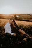 I had been looking at this dress for months in the burgundy color for our engagement photo shoot. By the time I was ready to purchase it, the burgundy was sold out. I was worried that the navy would blend in too much with my dark hair, but our photographer said it would be fine. I'm so glad I decided to get the navy! The quality of this dress is amazing, the lining feels so luxe. The skirt is  very long, and if I was wearing it anywhere but for a photoshoot, I would have had to have it hemmed. But I left it long specifically for pictures, and the slit and length added so much movement and drama to our pictures. I'm very busty, so I had to do some major taping to get the girls to sit right, and I really should have pinned it at the bottom, but it worked out fine. In the future, I'd probably put a small snap in at the bottom of the neckline to help hide the boob tape required. If you're very busty like me you likely wouldn't be able to wear a bra without it showing. - Norlyn F.