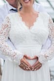 I contacted Lulu a week before my wedding because I hadn't received my other dress so I was starting to panic...I chatted with them about sizing because I'm 8 months pregnant and they were SO helpful. The only thing I had to get altered were the sleeves, which were a little too long. Otherwise it was the perfect maternity wedding gown! - Abby B.