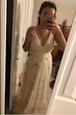 I got this dress to possibly elope in, and I thought it would be perfect since it is simple and unique. When I received it, I was very underwhelmed and not excited about it. I think it came down to personal taste, but also the fact that the tulle at the top around the bust was not very flattering as it wasn't sewed down very well (in my opinion). Also, most of the embroidery was tattered and didn't look nice. I know the dress is $100, so I guess you get what you pay for. I ended up returning. - Autumn W.