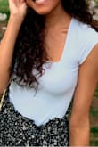 This shirt is so flattering, I always get compliments on it when I wear it. Also, it's so comfortable, the material is a bit stretchy, you can definitely move in it. I was worried about the arms being too tight but that wasn't a problem! Also very good quality - Natalia M.