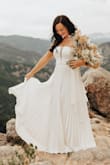 I wore this dress to my wedding elopement pictures and this thing photographs like a dream! the material was so beautiful. It was a little long but nothing a hem would not fix! I loved this dress so much!!!! Would buy again in a heartbeat - Emily C.