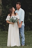 This dress is gorgeous! I wore it for my elopement in Kentucky in August and didn't get too hot even though the fabric is substantial. It's so beautiful. I did have to have it hemmed quite a bit, but I wore boots with not much of a heel. It's so much prettier than the pictures! - Meaghan O.