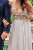 I wanted a wedding dress that was more in tune with a small and intimate wedding we were planning, but also wanted a dress that I wouldn't normally buy or wear for the special occasion.  About 10 dresses later , this one was a shoo in.  I didntt think I would be into all the bejewels as I thought I was at the age maybe I should be careful with it, but forget that concern!  It is enough to make you stand out but not over the top.  Hemming was necessary for the length, and has ZERO stretch so I had to just make sure to not gain ANY weight.  I am more athletic build and not much curve, in case that information helps anyone.  Cannot beat the price for nor the quality!  

One thing: a yr and half later in a protective bag, all the metals have rusted to a point of no return.   I wanted to dye and wear for a different occasion but didn't do anything special to protect it after wearing it during a humid season.  Just a note from someone that loved it enough to try and wear it again :) - SK