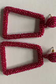 I bought these to wear with a black top for a pop of color, and that is just exactly what it does. It appears darker in the picture, but in person, it is a little brighter. Very cute way to dress up a basic top. Another pro is how lightweight it is. Some statement earrings can be so heavy. Overall, a great purchase! - Krishna R.