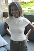 It could be that I'm extra petite! Love this top, ordered the XS and for the most part, the top portion of the bodysuit fits well. The bottom area felt slightly baggy on me which then made walking a bit awkward lol! I eventually tightened that area by pulling it up and having a bit of extra fabric near my waist but still able to tuck in my pants. I'm hoping a run in the dryer will shrink it slightly. This would be a perfect fit for someone with a slightly longer torso...or someone taller than me haha! Still I received compliments at the office and boyfriend approved...so am happy. - Megan S.