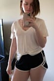 I have the blue in the XS which fits perfect, but the S in white fits great in a more flowy way with a more revealing v neck. Looks great tucked into sport shorts and jeans or loose over leggings. It's pretty see through but in a sexy way. You can choose to be bold with a dark bra or nude/pink bras are almost invisible. - Katie B.