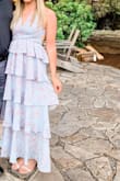 I wore this dress to a summer outdoor wedding and it was perfect all around! I typically order size small but read the comments that said it was stretchy and to size down. So, I ordered an x-small and it fit perfect and the best part is that you can tie the top in many different ways to fit to your liking and if you want it tighter or looser you can adjust with the top. Length was perfect too and I wore a 2 1/2" heel. The material is really nice and not cheap looking at all and I received many compliments on the look of the dress (the ruffles are so pretty!) and easy to dance in. You won't be disappointed :) - Brianna L.