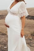 Ordered this dress for my maternity shoot in a M (not pregnant I am a S) and absolutely loved it! It worked out perfectly and fit better than I expected. The dress was not at all see through and wasn't too tight on my 34 week belly. The fabric doesn't have stretch to it, but sizing up 1 size worked perfect. - Bonnie C.