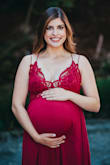 I was having such a hard time finding a dress with beautiful detail for maternity pics. This dress turned out to be so perfect! The color and details photographed beautifully and it showed off my boobs and bump just how I wanted. I am normally a size 4, 125-ish lbs and 5'5". I was 33 weeks and ~155 lbs at the time these pics were taken and the size L was perfect. I am normally a 34B and was wearing a 34D bra at the time. I don't think a bigger bust could fit the top part comfortably or without stretching it too much. So many pros about this dress from the adjustable straps to the ruffle detail on the bottom and waist/bust lace detail. It's worth the money for sure. - Sarah L.
