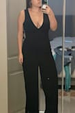 There's a reason this jumpsuit is loved by tall girls in the reviews. It is long in the crotch by about 3-4 inches on me. There is a seam under the bust which is not obvious in the photos. I am a 32G and my boobs do actually fit in this, but if you have a larger bust, they will be on display. I am a classic medium in Lulus and a medium is the correct size in the garment. It's just not made for anyone 5'4" or shorter, or anyone with a short torso. Unfortunately, I bought it final sale and it cannot be returned, so I will end up spending more than I paid to have it altered to fit. Even if you have a longer torso, if you're in the 5'4" range, the length will still need a hem unless you're wearing very tall heels. - Hannah G.