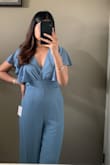Bought this for a brunch day out and got so many compliments! I'm more on the conservative side so I love how this has sleeves and doesn't show too much skin. The color is stunning and fits true to size. It has a full zipper with a clasp at the top and an attached tie for the back which is mainly just for show. If you are shorter than 5'7 you will have to alter the bottom or wear high heels as it is 32". - Pooja P.