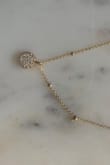 This is a delicate necklace that pairs well with mostly any outfit. It is just the right amount of gold - not too yellow. It looks so chic and more expensive than it is. Definitely eye-catching. Overall, I am very happy with this purchase and highly recommend! - Krishna R.