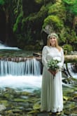 I absolutely love the lace details on the dress and the simplicity of the skirt. It was a perfect gown for our nature-inspired destination wedding! I had the neck-line lowered and had it hemmed on the bottom and sleeves to fit. - Lauren N.