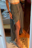 True to size. Love this skirt. Does not have any stretch, so had to be sure there was not bloat the day I wore it. Looks great with heels, or wedges. Because I am shorter, I would have to get it hemmed if I wanted to wear it with flats. Highly recommend it. You can dress it up or down. - Jona F.