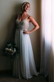 The detail in this dress is so beautiful I want to wear it again! I am 5'3 and 125lbs. I was in between purchasing the size 2 and 4 and very happy that I went with the 2. The shoulder straps are the perfect length where they didn't fall down. I did end up getting 4in taken off the outer chiffon piece. It was just too long for my preference. I'm considering shortening it above the knees for our elopement party. There are built-in cups. There are additional beads, but mine have held on strong. I received so many comments, little did they know it only costs $250!! - Kali D.