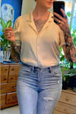 Very cute on, true to size. Kind of boxy so looks better tucked in. Isn't very long in length but isn't cropped, I wore it with high waisted pants and it barely tucked in. It wrinkles very easily and the material is thin (but not see through). I'm just afraid it won't hold up very long. - Erin M.