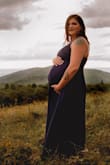 I wore this dress for my maternity photos. It fit like a glove and was so flowy and elegant. The scalloped neckline was also a nice feminine touch that I think really made this dress stand out. So in love with it! I didn't go up in size with my pregnancy so I'll still be able to get many wears out of this once baby is here. It leaves lots of room for your bump if you're considering maternity photos. - Amberly W.