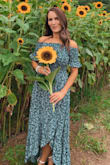 This dress is absolutely perfect! It fits amazing & is super flattering. The top fits snugly and stay in place rather than always sliding up like off the shoulder tops often do, and the ruffle detail in the sleeves is a nice feminine touch. Length is great with heels, and much easier to walk in than a maxi dress. I wore it for family photos to a sunflower farm & it looked amazing!! - Holly H.